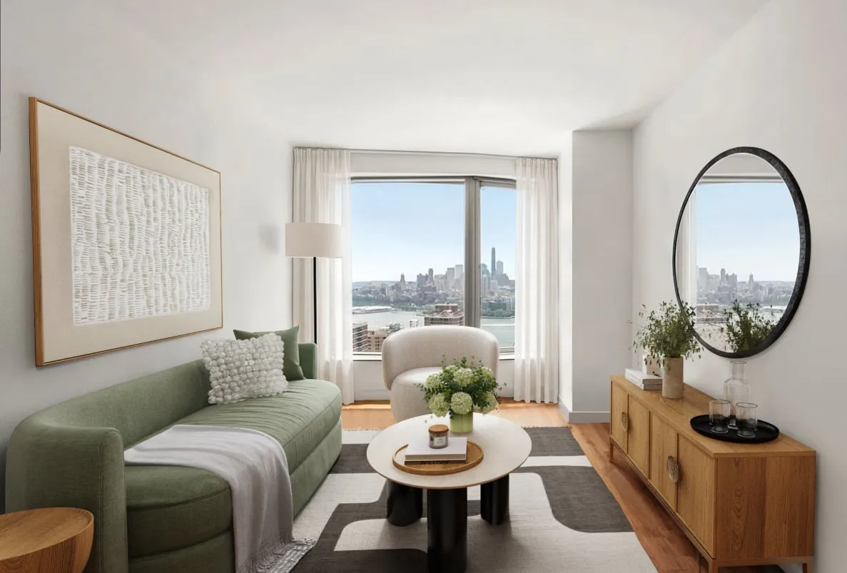 Living room with a green sofa and a city view
